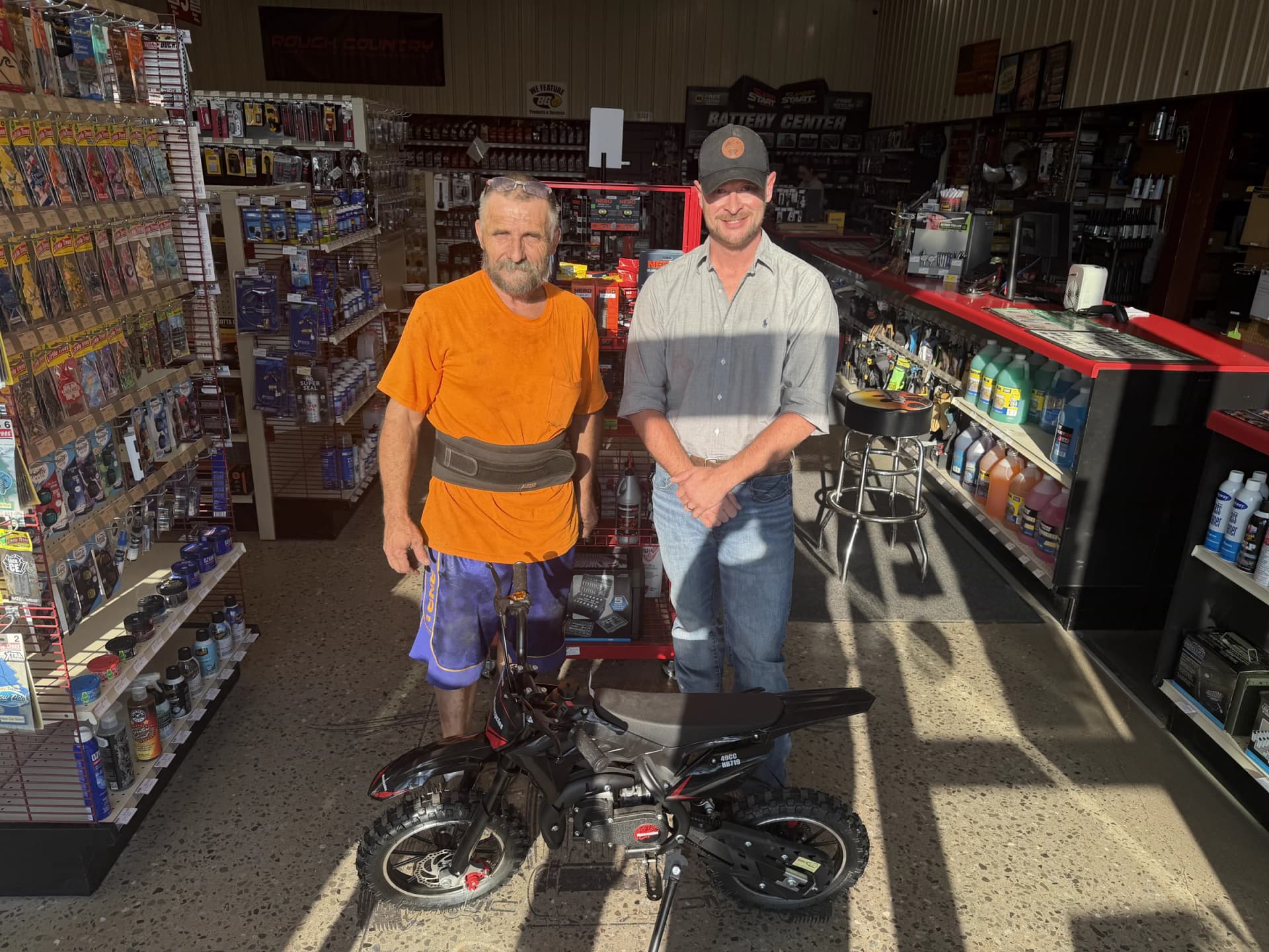 Jack Skidmore and a Parts City representative with the motorcycle giveaway prize